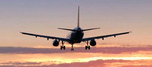 Plane landing at sunset